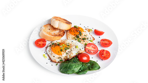 Fried eggs with vegetables and toasts on white plate isolated on a white background. Beautiful breakfast.