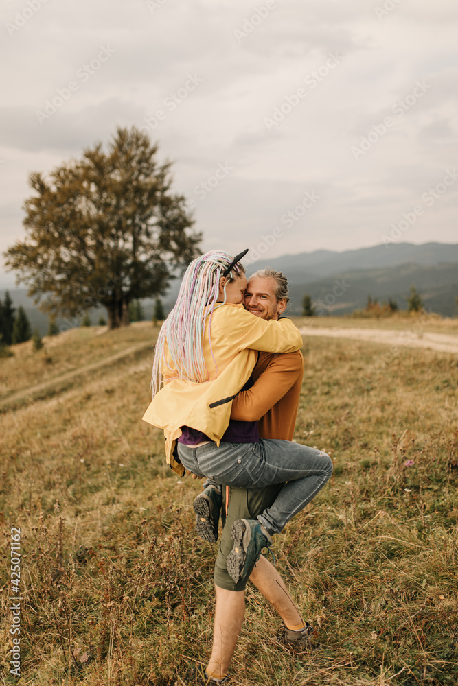 couple in love enjoying each other and walking in the mountains couple in love enjoying each other and walking in the mountains