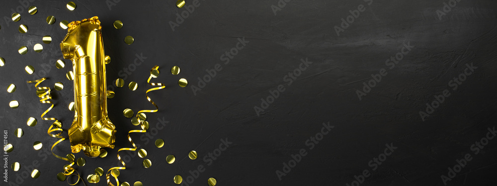 gold foil balloon number one or first, birthday greeting card with the inscription 1. black concrete background. Celebrating the anniversary. Banner. gold foil balloon number one or first, birthday greeting card with the inscription 1. black concrete background. Celebrating the anniversary. Banner.