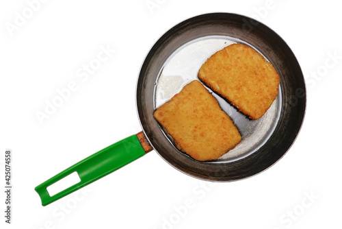 Juicy appetizing cutlets from a mixed different types of meat in a dripping pan in oil. isolated on white background. top view. photo