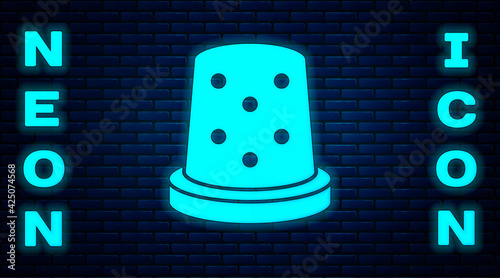 Glowing neon Thimble for sewing icon isolated on brick wall background. Vector