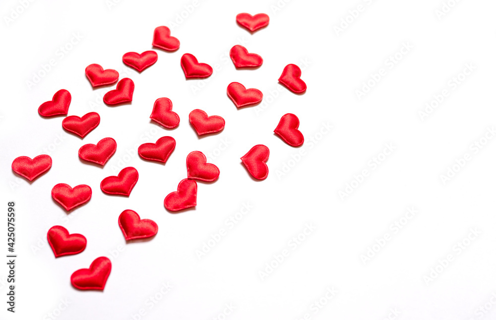 A lot of volumetric textured red hearts on a white background. Valentine's day background, wedding, love and romance. Seamless hearts. view from above. Flat lay. copy space for text, modern background