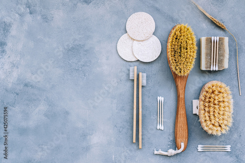 Natural eco friendly accessories for self care  dry massage brushes  bamboo toothbrushes  loofah facial sponges and natural soap.