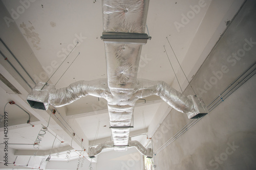Ducting work for air conditioner ceiling type. Installation AC Ductwork in the construction site.