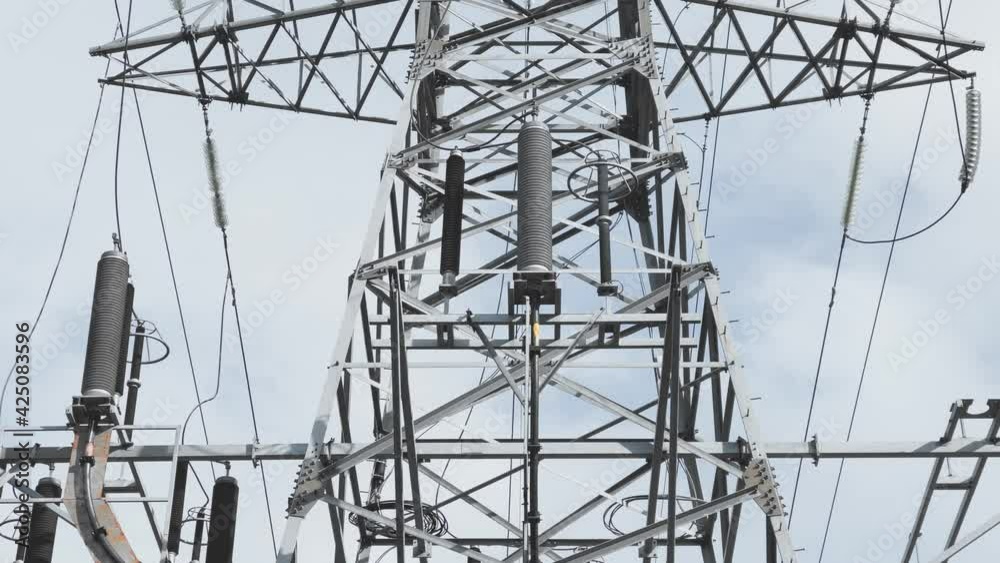 Huge Metal high-voltage tower with electric wires, the bottom view up ...