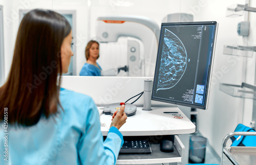 In the hospital, the patient undergoes a screening procedure for a mammogram, which is performed by a mammogram. A modern technologically advanced clinic with professional doctors. photo