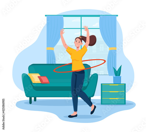 Young pretty girl is twisting hula loop at home