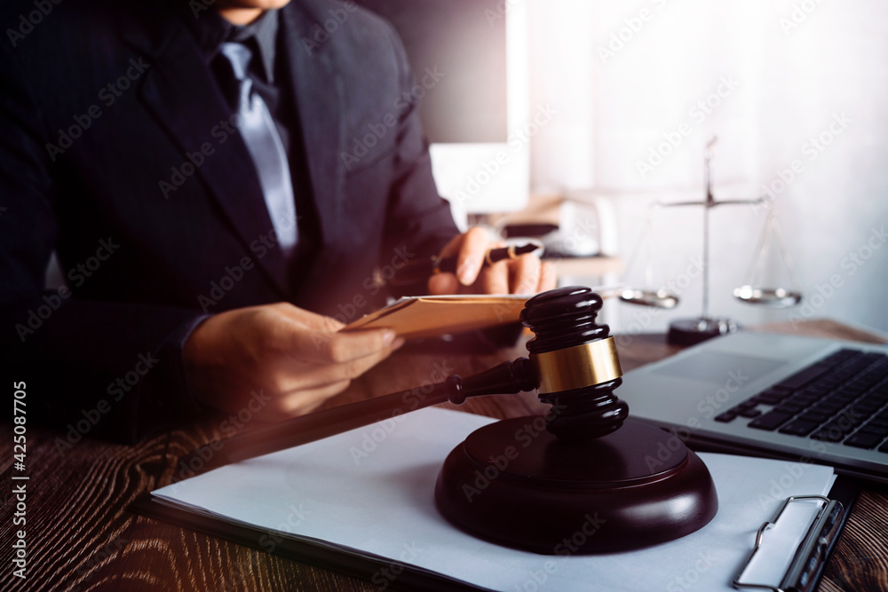 Business and lawyers discussing contract papers with brass scale on desk in office. Law, legal services, advice, justice and law concept picture with film grain effect