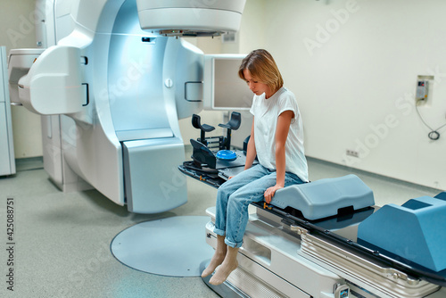 A young woman is undergoing radiation therapy for cancer in a modern cancer hospital. Cancer treatment  modern medical linear accelerator.