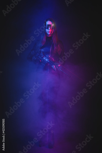 Cyberpunk girl soldier with a rifle in the neon lights concept.