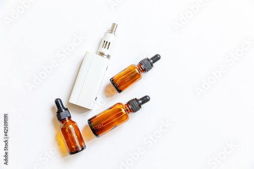 Vaping device e-cigarette electronic cigarette and liquid bottles isolated on white background. Vape device for alternative smoking. Vaping shop concept. Gadget for vaper. Vaping accessories.