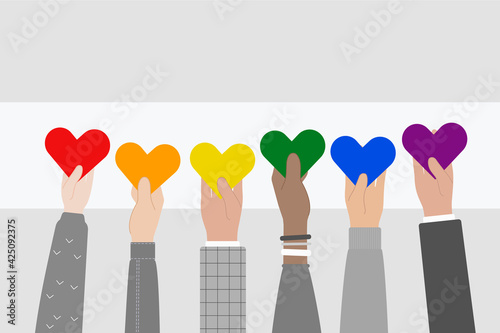 People's Hands Holding Hearts in Rainbow Colors. LGBTQ Pride Flag.