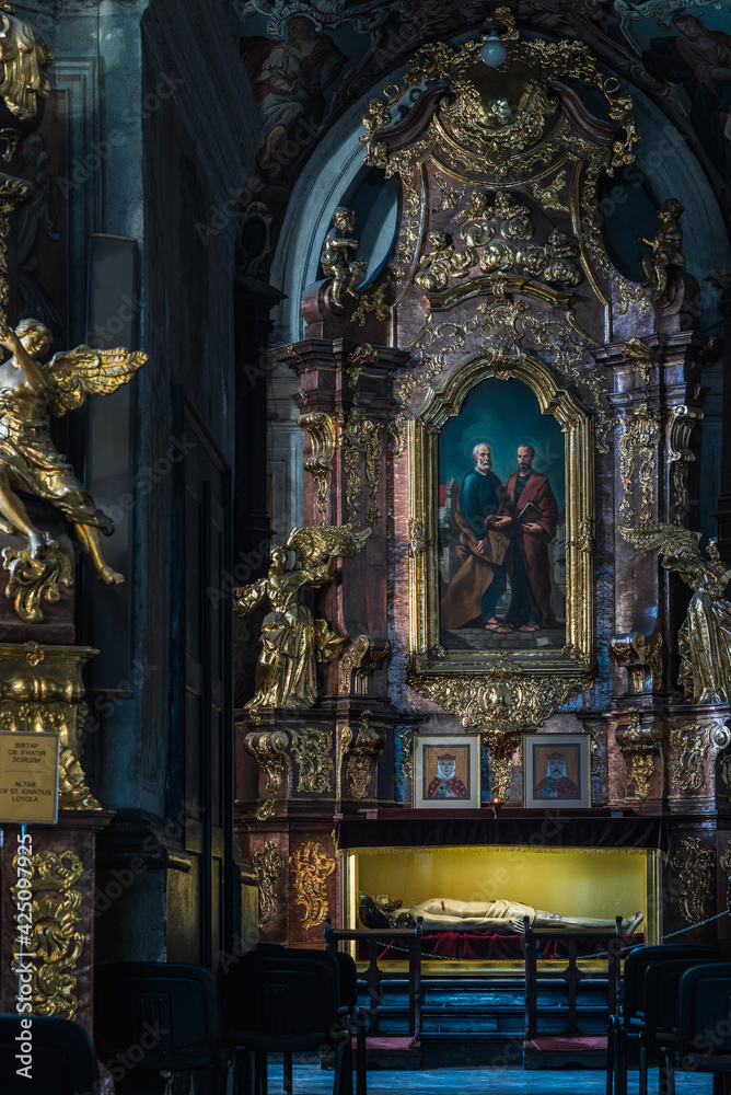 LVIV, UKRAINE - April, 2021: Saints Peter and Paul Garrison Church. Altar of the Apostles Peter and Paul with the sculpture 