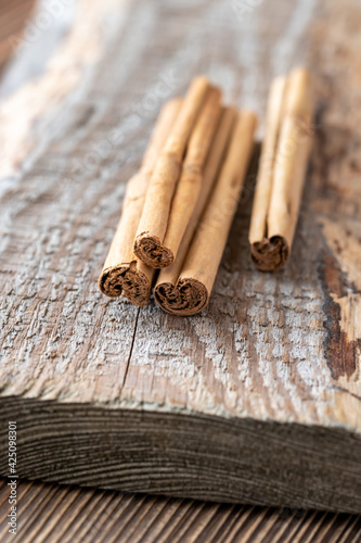 Fényképezés Cinnamon sticks on the wooden background