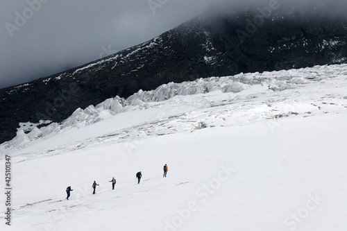 Team of alpinists traversing the Teischnitz Glacier,  Grosklockner - Hohe Tauern National Park, Austria, Europe photo