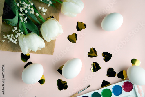 top view on easter table. Easter layout with eggs, paints and flowers. preparation for Easter. selective focus 
