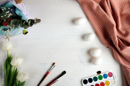 Easter layout. Frame of easter eggs and paints. Preparation for Easter. place for text. selective focus 