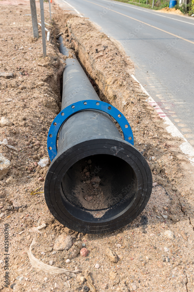 Construction site with new Water Pipes in the ground. sewer pipes to repair or restore in street city Construction site with new Water Pipes in the ground. sewer pipes to repair or restore in street city