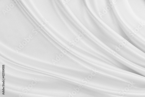 Smooth elegant white silk or satin luxury cloth texture as wedding background. Luxurious background design