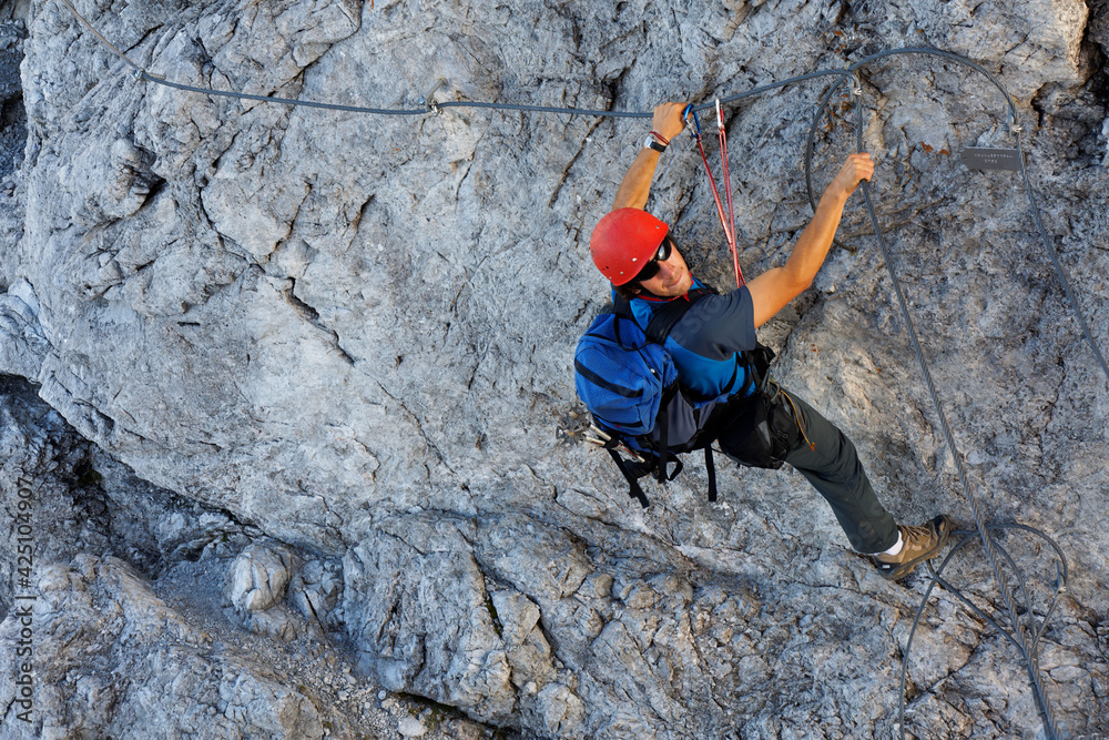 Young alpinist climbing on Koenigsjodler route, Austria Young alpinist climbing on Koenigsjodler route, Austria