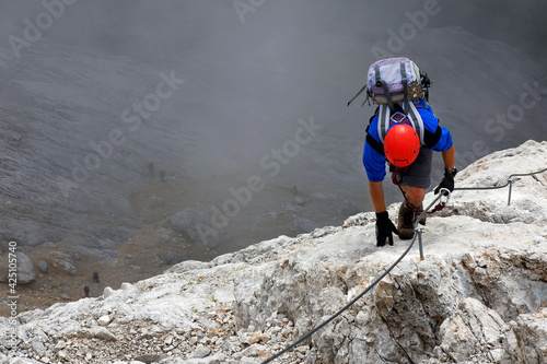 Young alpinist climbing on Koenigsjodler Ridge, Austrian Alps, Europe