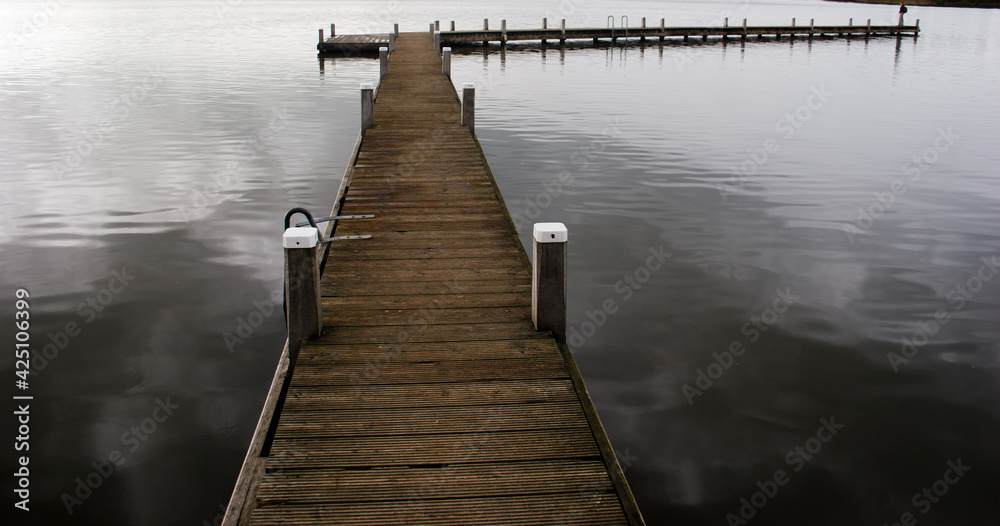 Fototapeta premium Pier on the Reeuwijkse Plassen (Lake, The Netherlands), created by digging for peat, now very popular for watersports and recreation.