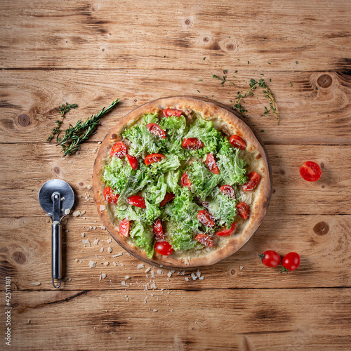 Vegetarian pizza on a wooden background. Top view. Flat lay