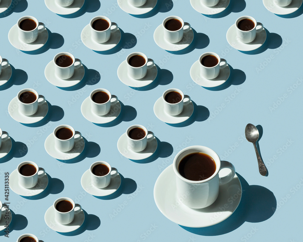 Rhythmic pattern from cups with coffee on a blue background.