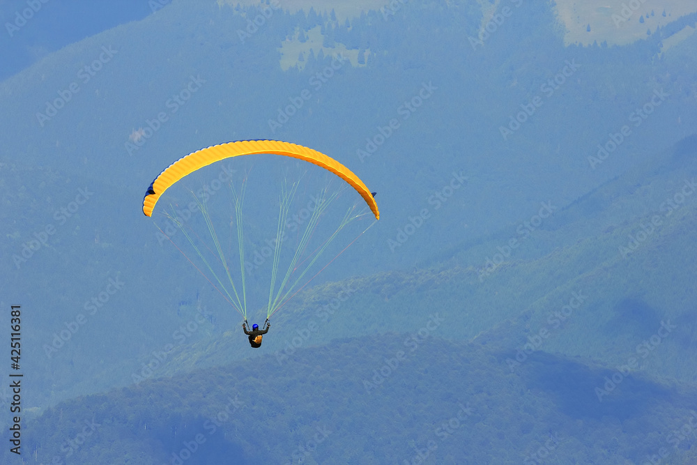 Paraglider prepareing to take off from a mountain Paraglider prepareing to take off from a mountain