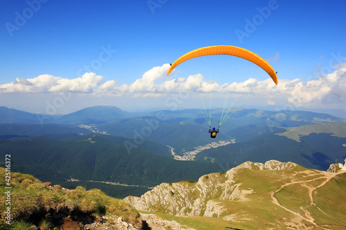 Paraglider prepareing to take off from a mountain photo