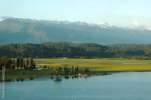 An ancient relict lake in Pitsunda. Mountains covered with snow in the background. Voluminous white clouds hang over the mountains. Abkhazia. Incit.