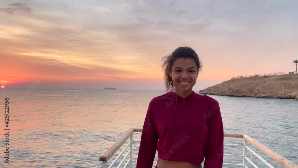 The beauty of morning. Cheerful young woman turns around and walks along the pier towards camera. The camera zooms back. Slow motion. Healthy lifestyle, nature concept The beauty of morning. Cheerful young woman turns around and walks along the pier towards camera. The camera zooms back. Slow motion. Healthy lifestyle, nature concept