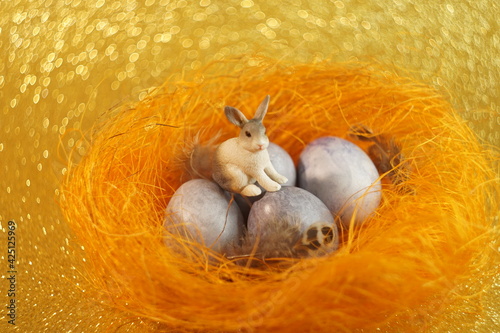 Beautiful easter eggs lie in a bright orange nest
