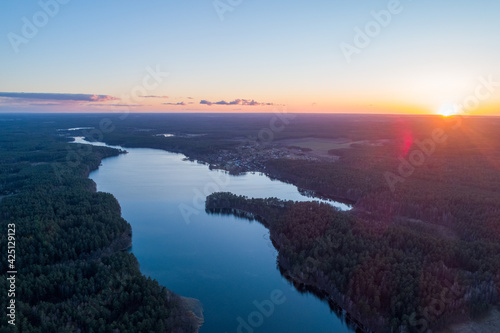 Fototapeta Naklejka Na Ścianę i Meble -  Sunset over the lake in the middle of the forests. Relaxation and calm in a natural landscape.