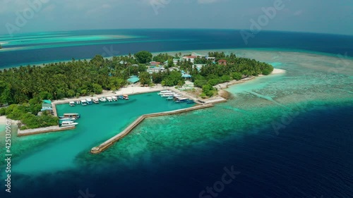 Drone view of a tropical island with a hotel and residential property. Thinadhoo (Vaavu Atoll), Maldives