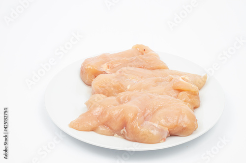 Raw Chicken Breasts on the plate above white background