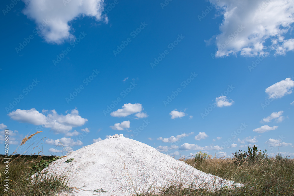 Chalky hill on a background of blue cloudy sky. Chalky hill on a background of blue cloudy sky.
