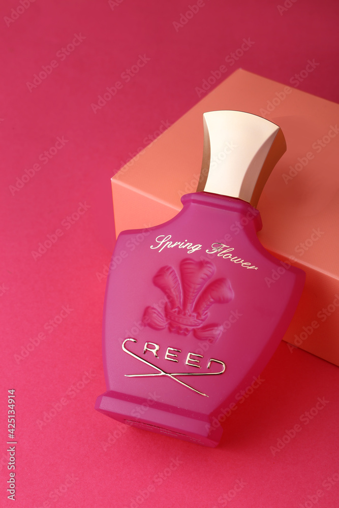 Jeddah Saudi Arabia March 31 2021 Spring Flower Creed Perfume bottle .Floral  scent concept. Perfume bottle with flowers over pink pastel background Flat  lay and copy space top view. Stock Photo