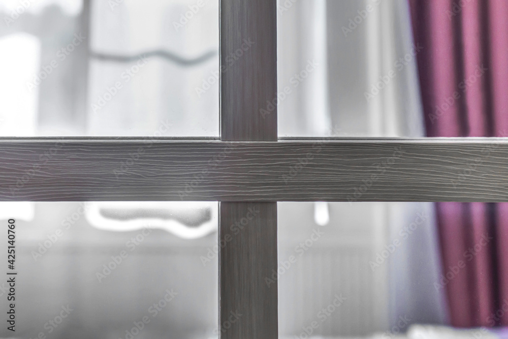 A room with a purple curtain is crossed by two wooden beams / cross by four A room with a purple curtain is crossed by two wooden beams / cross by four