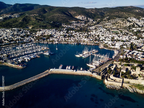 Amazing panoramic view from drone of beautiful full of yachts Bodrum harbour and ancient Kalesi castle in Mugla province in Turkey
