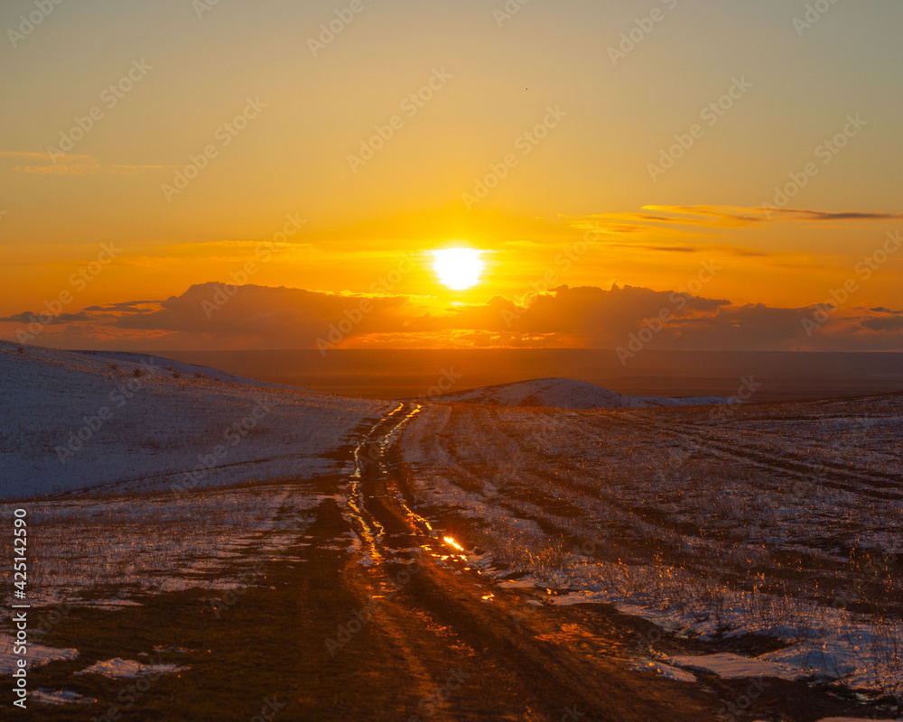 Sunset view of countryside road in spring, Shengeldy, Kazakhstan