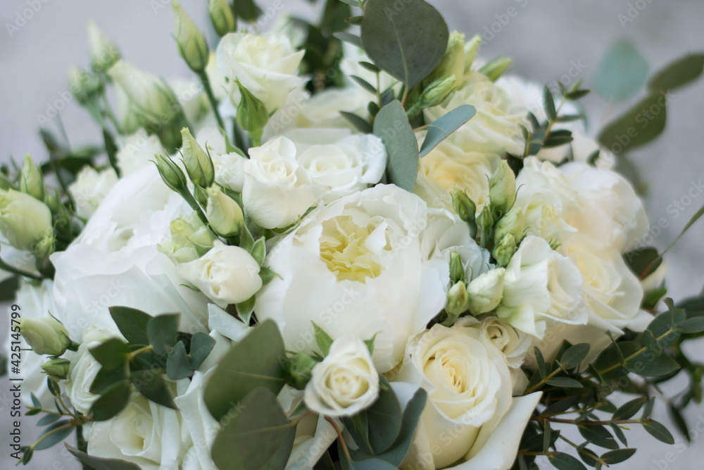 White wedding bouquet omposed od peony, roses, lisianthus, freesia and eucalyphus. Close up.