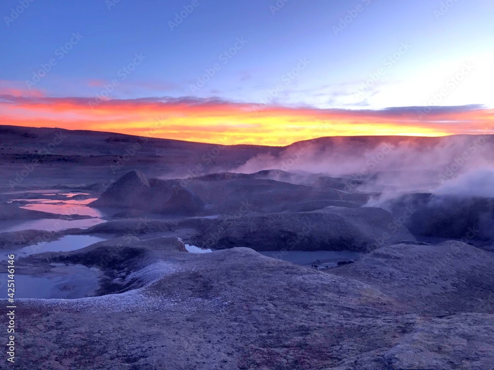 Sunrise in Geothermal valley Salar de Manana Bolivia. Smoking geysers, fumaroles at sunrise light, incredible volcanic nature. Alien martian landscape.