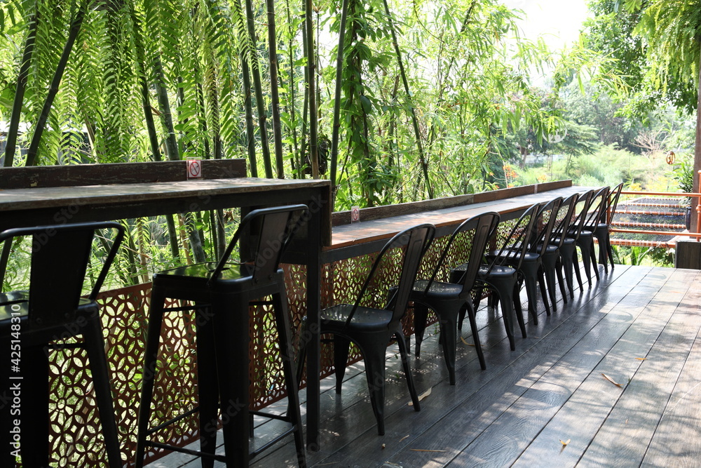 chair and table on a sun terrace. wooden garden old painted benches and table,beautiful picnic area with wooden table and blooming rhododendrons,chair in green garden terrace , Home lifestyle chair and table on a sun terrace. wooden garden old painted benches and table,beautiful picnic area with wooden table and blooming rhododendrons,chair in green garden terrace , Home lifestyle
