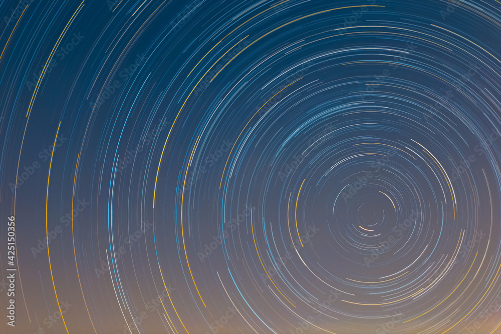 Obraz premium Colorful Spiral Star trails wallpaper background
