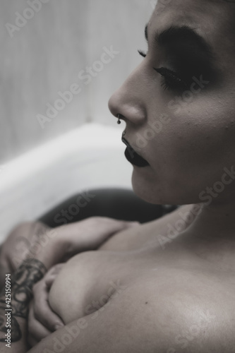 Mujer guapa en bañera con agua negra