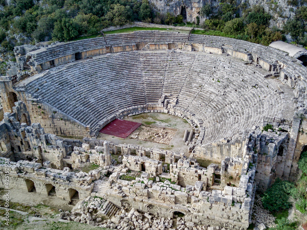 High angle drone aerial view of ancient greek rock cut lykian empire amphitheatre and tombs in Myra (Demre, Turkey)