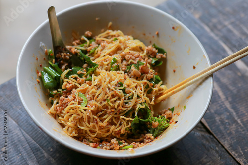 Dry noodles with minced pork in a bowl of noodles look delicious. Dry noodles with minced pork The Food of Thailand has a spicy flavor, Tom Yum seasoning.