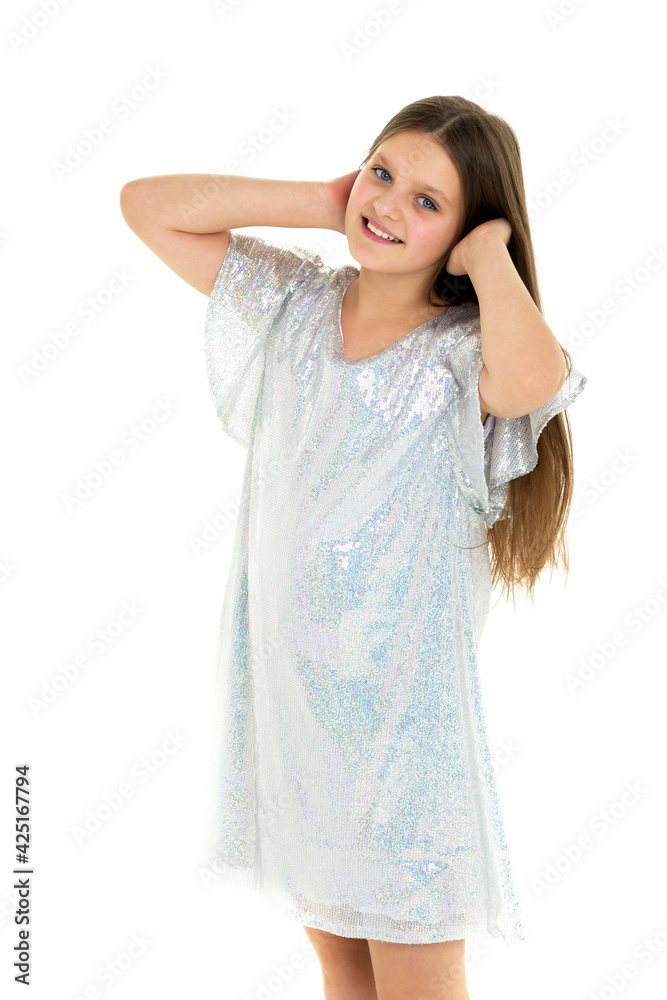 Happy teen girl in shiny dress. Photo session in the studio Happy teen girl in shiny dress. Photo session in the studio