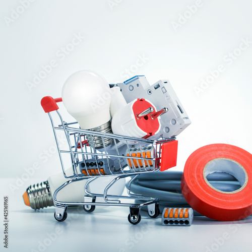 Electrical components and equipment in trolley. Shopping cart concept. photo